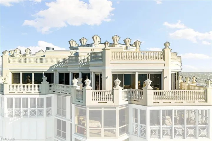 Back of property with a sunroom