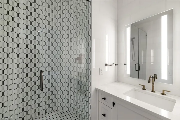 Full bath with a stall shower and vanity