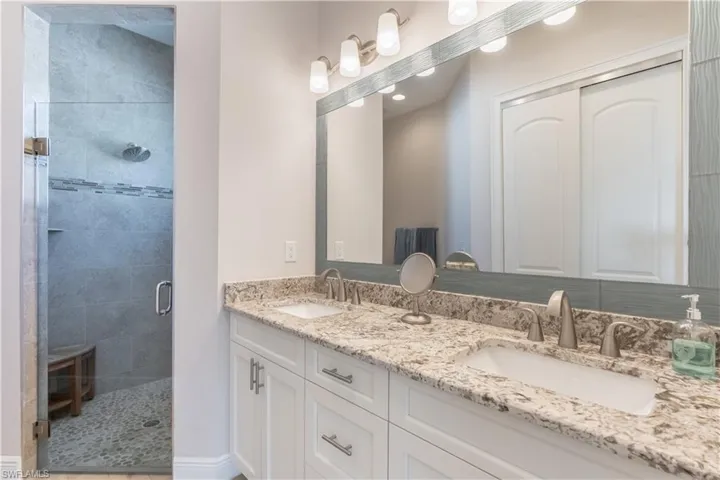 Primary Bathroom with vanity and a shower with shower door