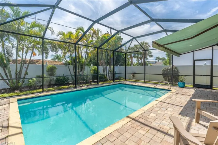 Pool featuring electric retractable awning.