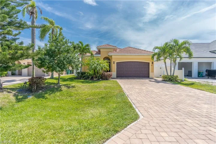 View of front of home with a garage and a front yard