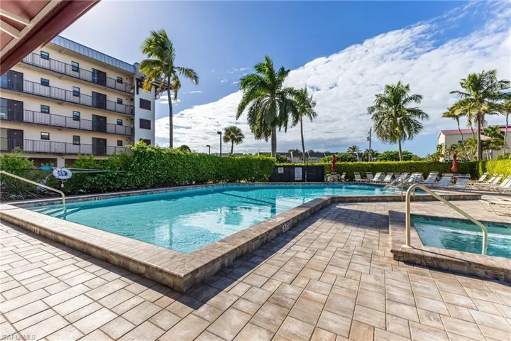 Community pool featuring a patio and a hot tub