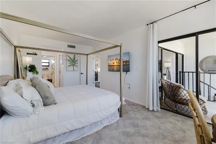 Bedroom with access to outside and baseboards