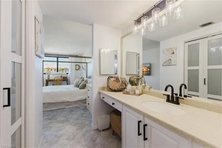 Ensuite bathroom featuring vanity and light tile patterned floors