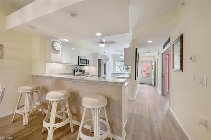 Bar seating toward kitchen and entry