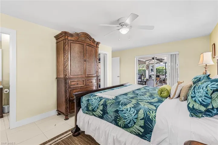 Primary bedroom with sliders to the pool, walk in closet and bath with walk in shower