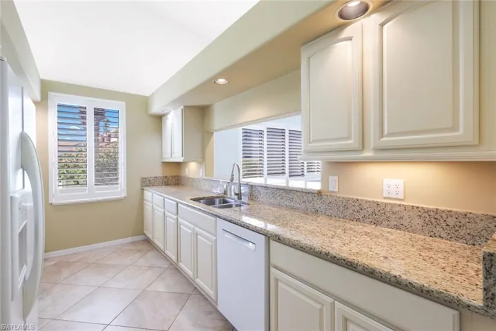 Lovely Granite Countertop with a 4" Backsplash, Quiet Dishwasher,  Ample Room for Kitchen Activity