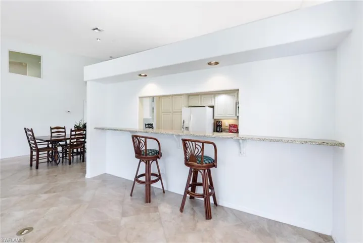 View into The Kitchen- Long Granite Breakfast bar- or hors d' oeuvres