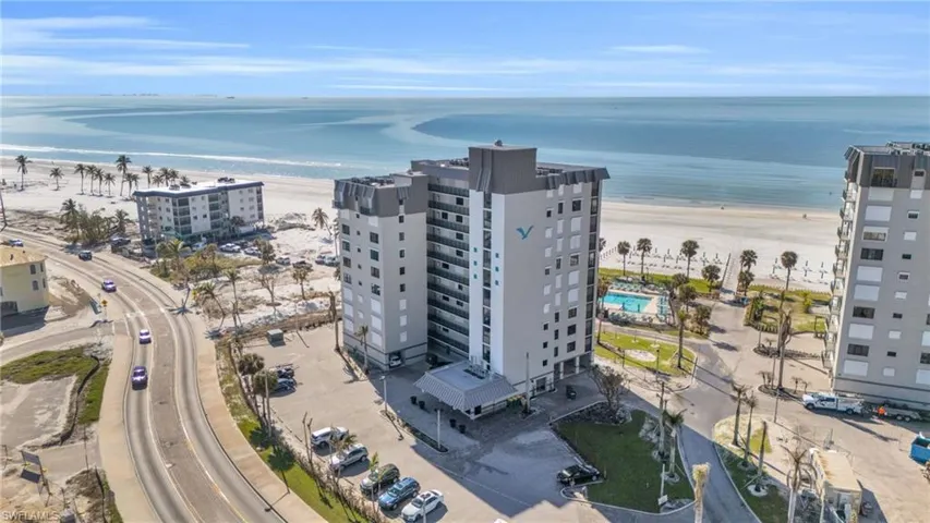 Aerial view with a water view and a beach view virtually enhanced image