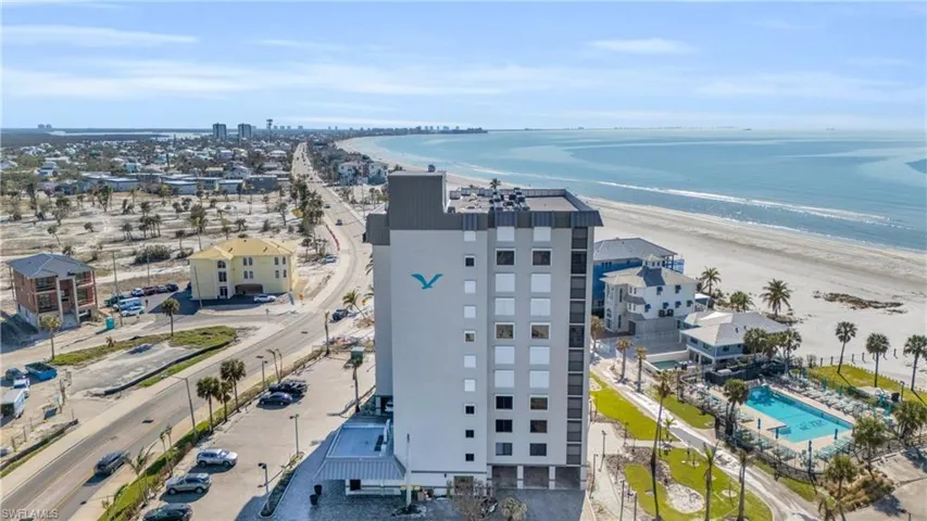 Bird's eye view featuring a view of the beach and a water view virtually enhanced image