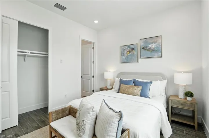 Bedroom featuring wood finished floors, a closet, and recessed lighting