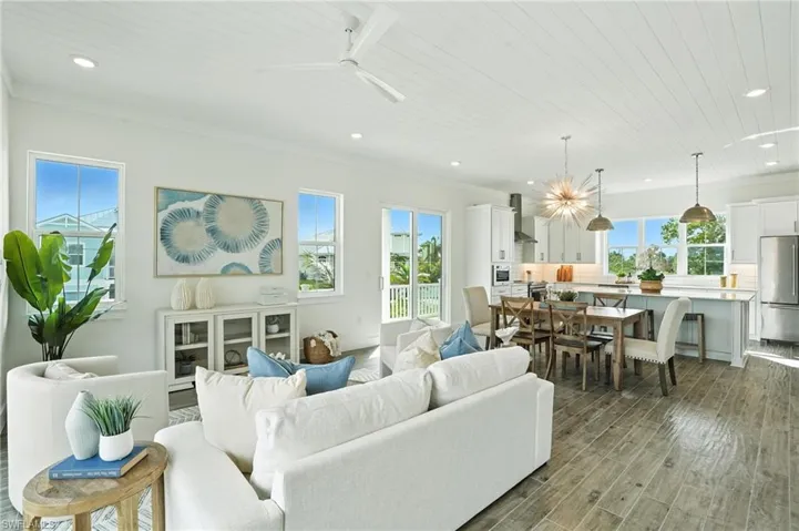 Living area with recessed lighting, healthy amount of natural light, light wood finished floors, wood ceiling, and ceiling fan