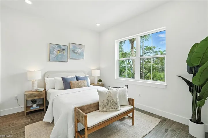 Bedroom with wood finished floors and recessed lighting