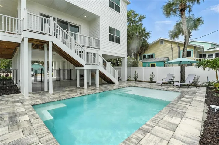 View of pool featuring a patio area and stairs