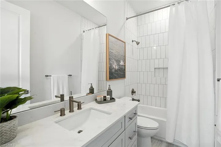 Full bath with vanity and shower / bath combination with curtain