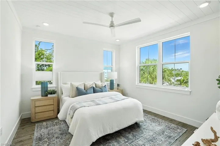 Bedroom with dark wood finished floors, a ceiling fan, recessed lighting, ornamental molding, and wood ceiling