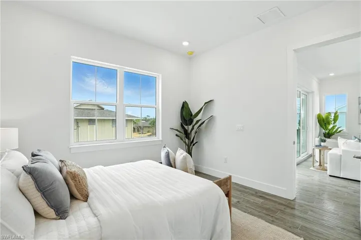 Bedroom with wood finished floors and recessed lighting