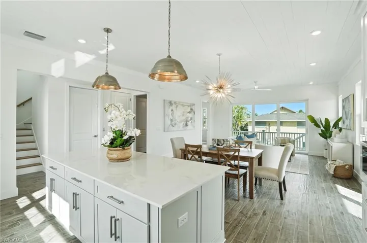 Kitchen with recessed lighting, light wood-style floors, decorative light fixtures, a center island, and wooden ceiling