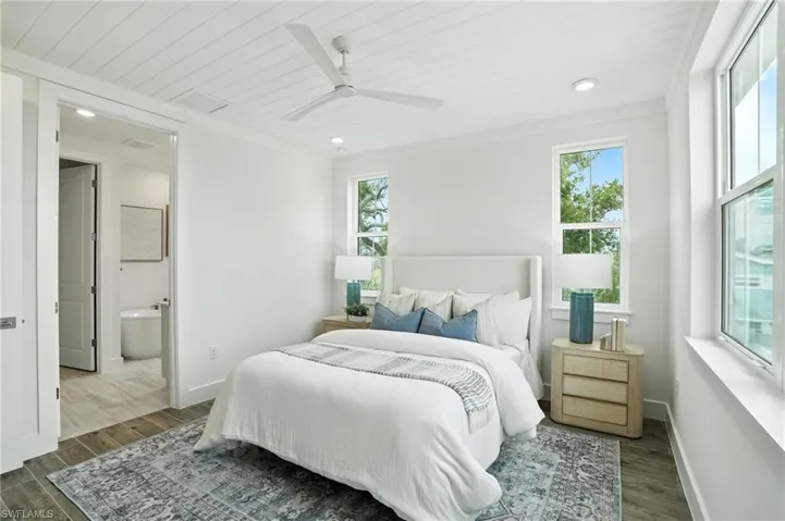 Bedroom featuring wood finished floors, multiple windows, wood ceiling, recessed lighting, and a ceiling fan