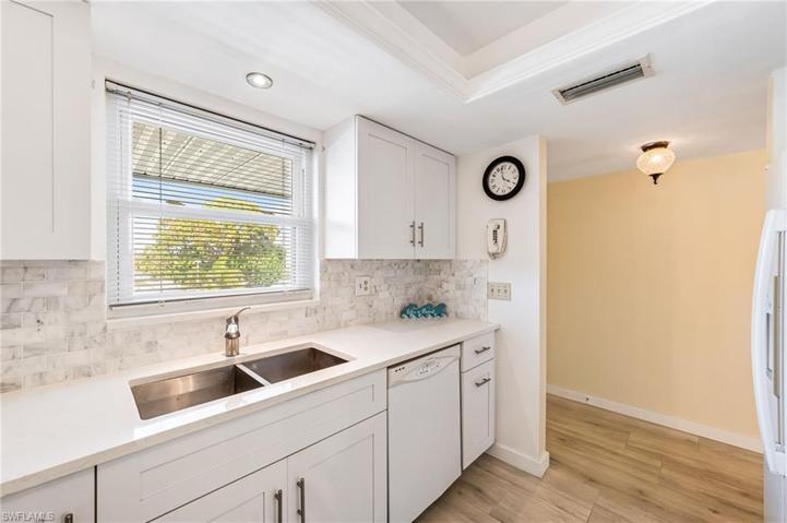 UPDATED KITCHEN...WHITE CABINETRY...QUARTZ COUNTERS..CUSTOM BACKSPLASH...TRAYED CEILING...WIDE PLANK TILE