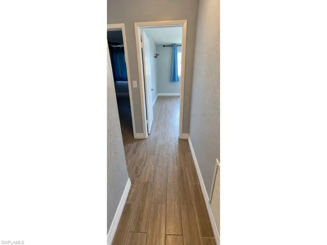 Wood-finish flooring throughout the hallway and into interior spaces