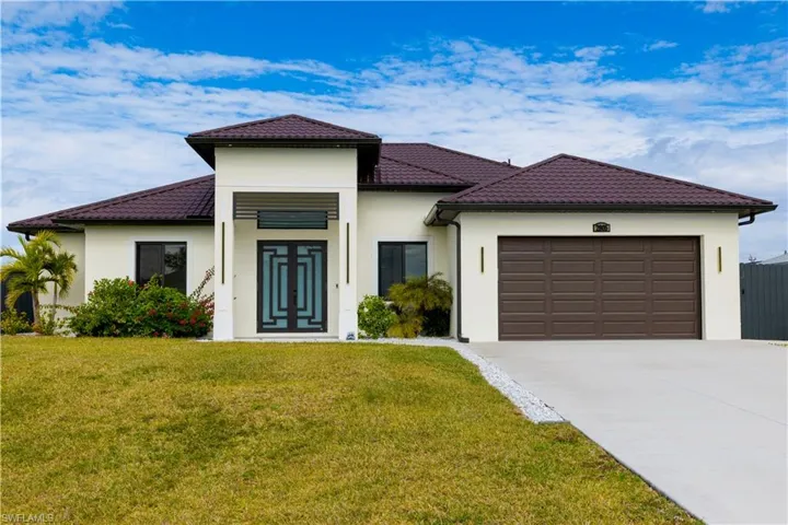 Mediterranean / spanish home with a garage and a front yard