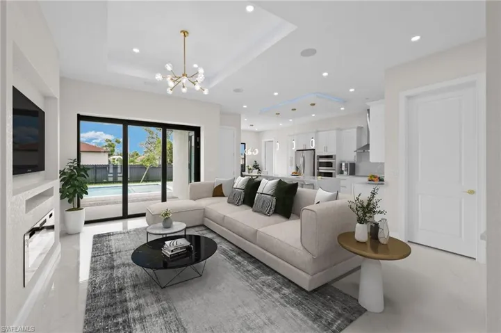 Living room with an inviting chandelier and a raised ceiling
