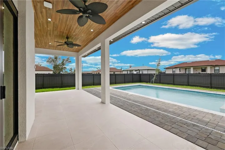 View of pool featuring ceiling fan and a patio area