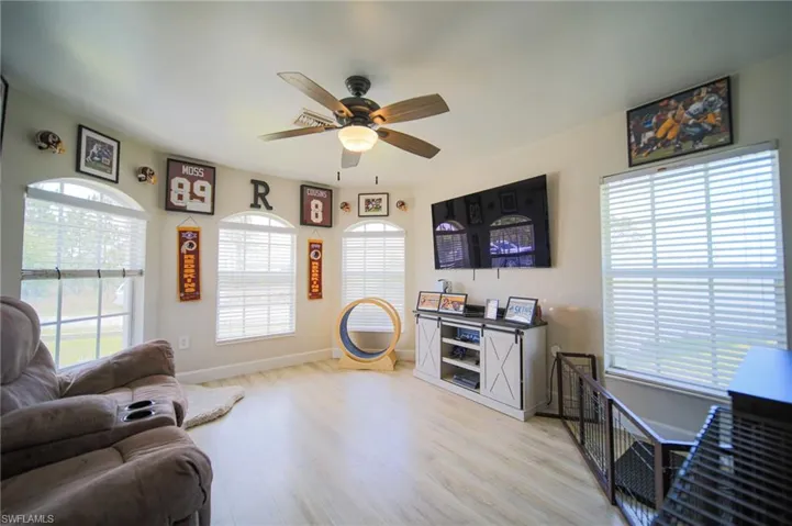 Living room featuring a ceiling fan and light wood-style floors