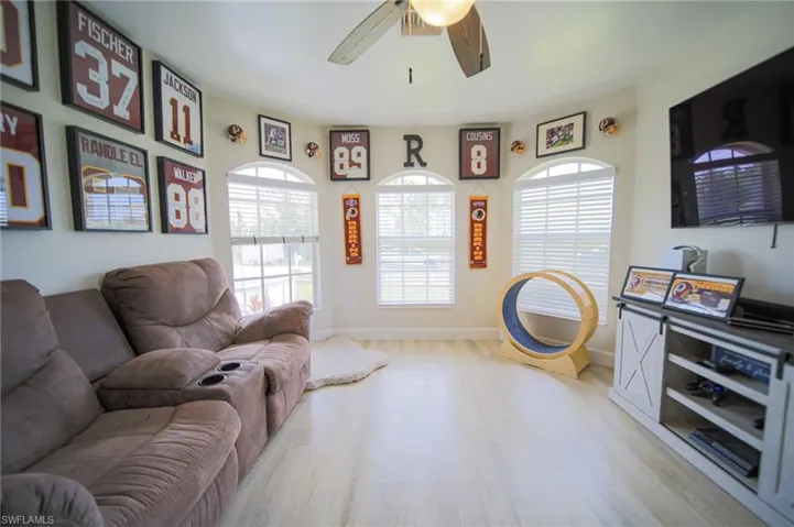 Living room featuring wood finished floors and a ceiling fan