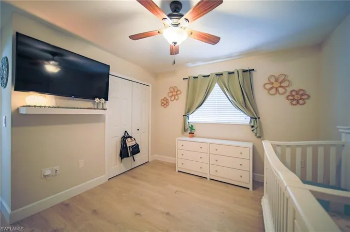 Bedroom featuring light wood-type flooring, a closet, and a ceiling fan