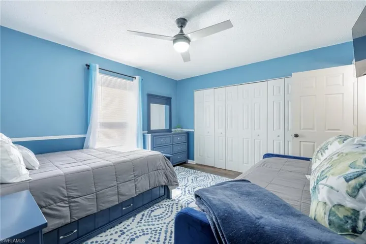 Bedroom featuring a textured ceiling and ceiling fan