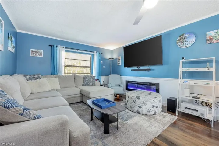 Living room featuring a textured ceiling and dark hardwood / wood-style flooring