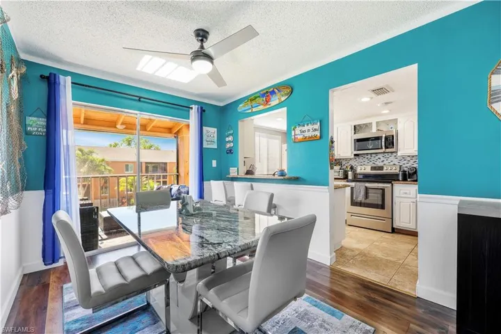 Tiled dining space with ceiling fan and a textured ceiling