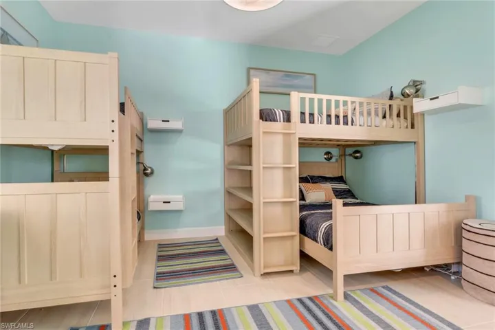 Bedroom featuring baseboards and light tile patterned floors