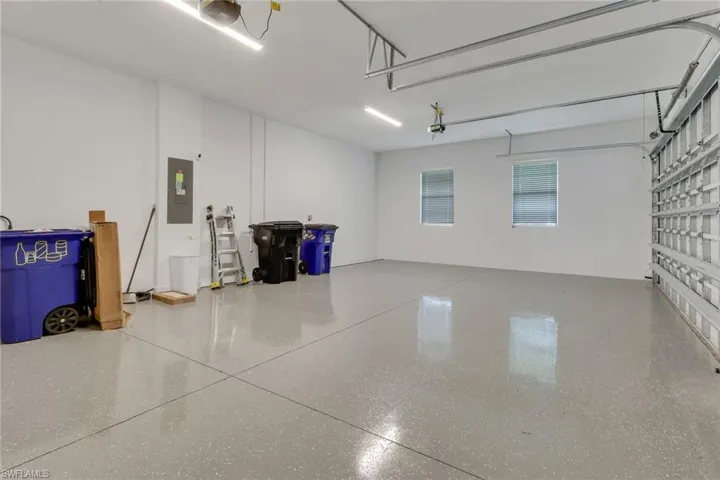 Garage with electric panel and a garage door opener