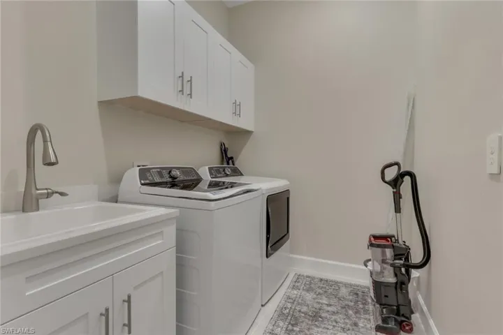 Laundry area featuring cabinet space and washer and clothes dryer