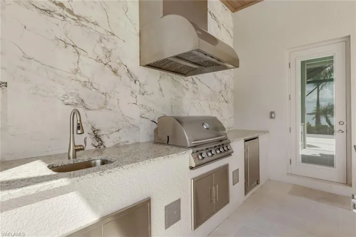View of patio / terrace with an outdoor kitchen and a sink