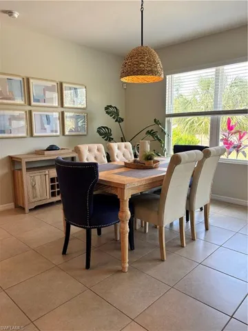 Dining room with light tile patterned floors and baseboards