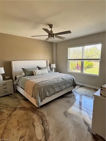 Bedroom with a ceiling fan and baseboards