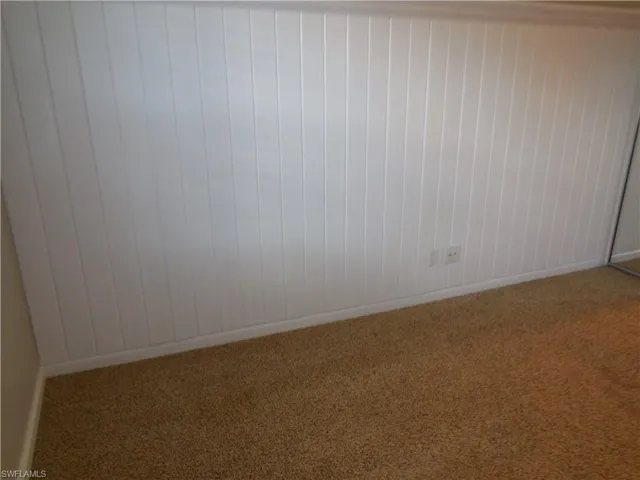 Empty room with carpet floors