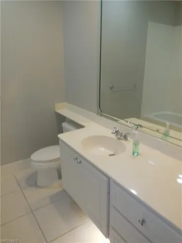 Bathroom featuring tile patterned floors, toilet, and vanity