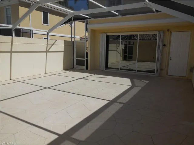 View of patio featuring a lanai