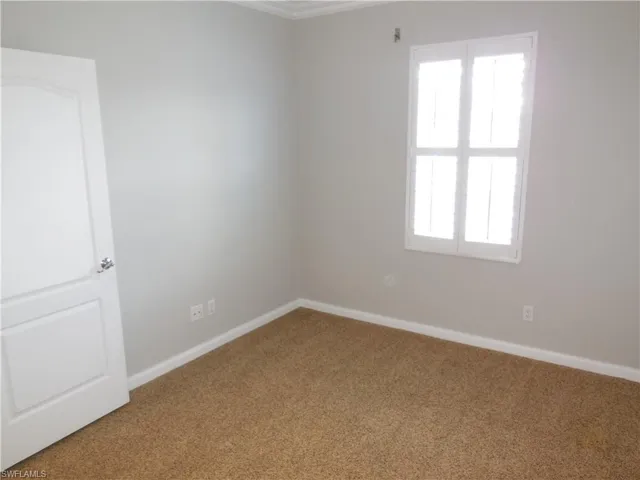 Unfurnished room with carpet