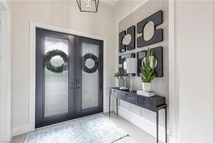 Bright Entrance with wall and ceiling custom trim and wall coverings