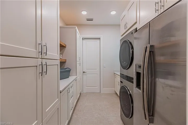 Custom laundry with XL washer/dryer, Fridge/Freezer, sink, and storage