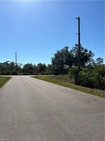 View of asphalt road with traffic signs