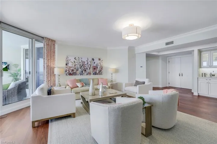 The beautiful living room with hardwood floors & crown moulding