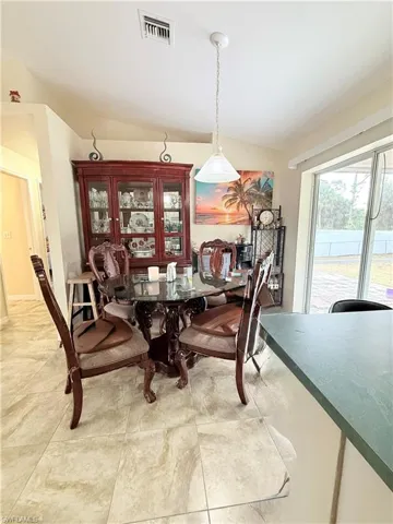 Dining room featuring vaulted ceiling