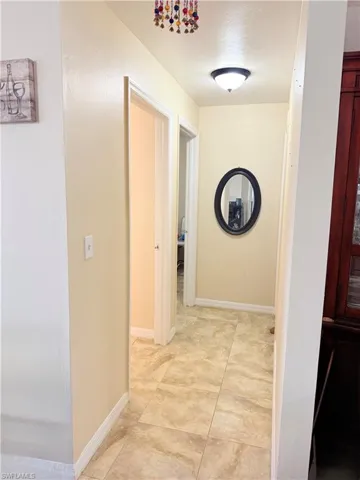 Hallway featuring baseboards